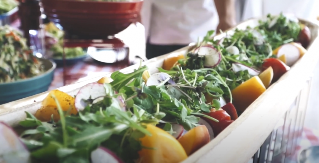 Photo of a healthy dish arranged on a long plate, showing a variety of herbs and vegetables