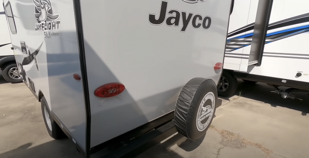 Photo of the back of the RV featuring text and a spare wheel