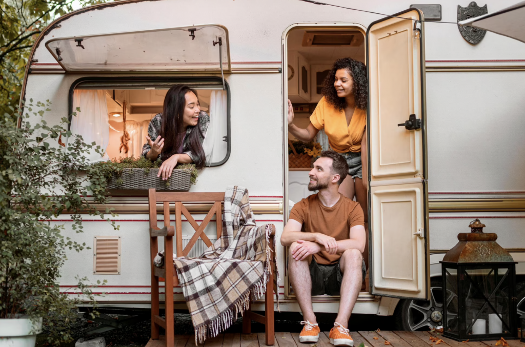 A group of friends relaxing in a travel trailer.