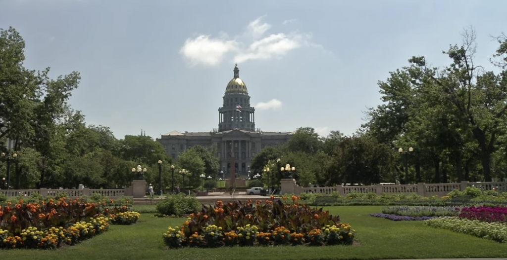 Photo of a park with a beautiful old building visible in the background