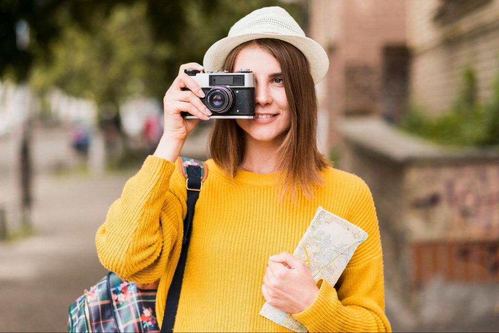 A tourist with a camera and a map