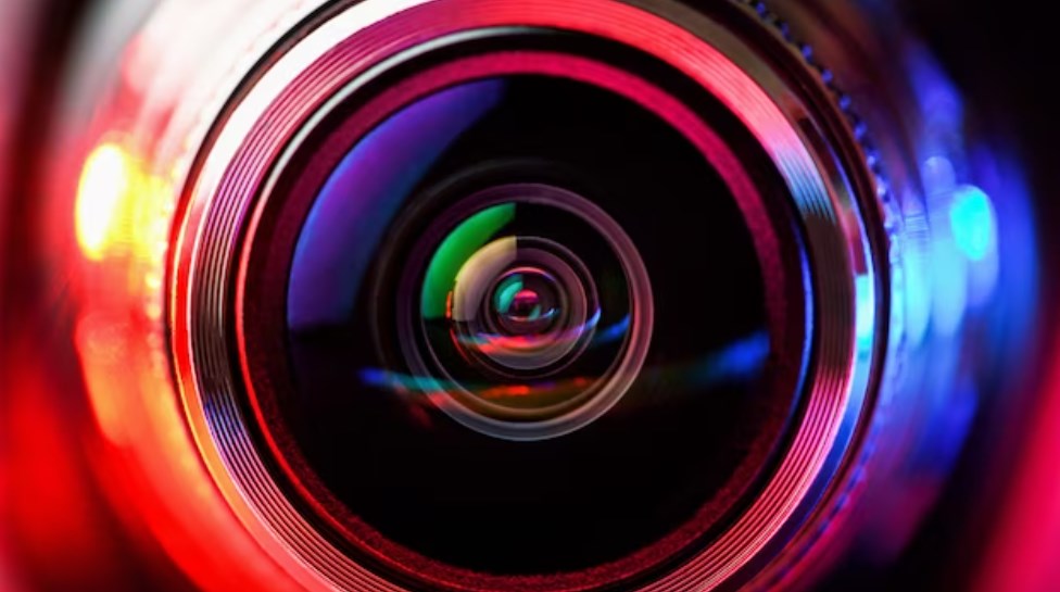 a close-up shot of a camera lens with red-and-blue backlight in the macro-photography style