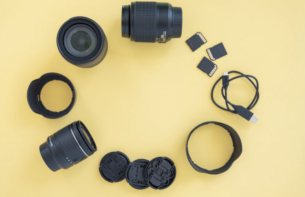 Digital camera accessories arranged in a circle over a yellow background.