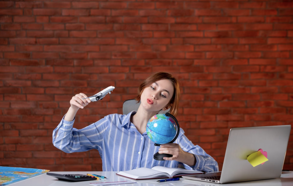 A travel agent with a toy airplane and a globe in her hands.