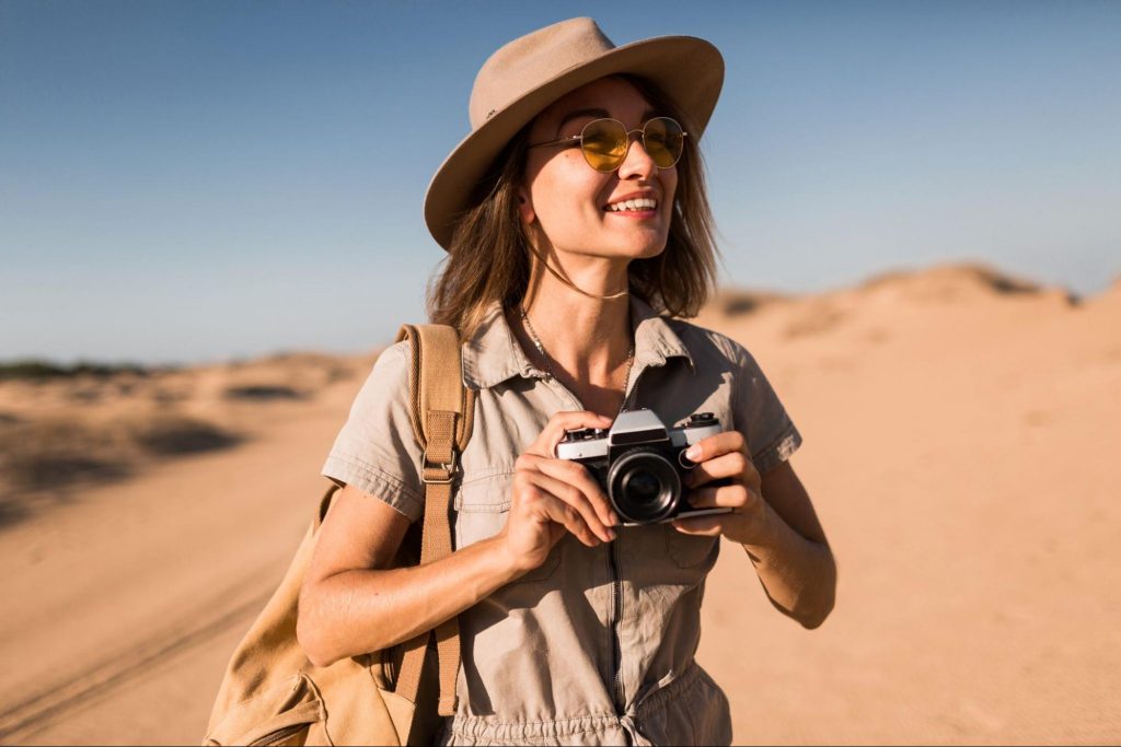 A woman with a camera travelling